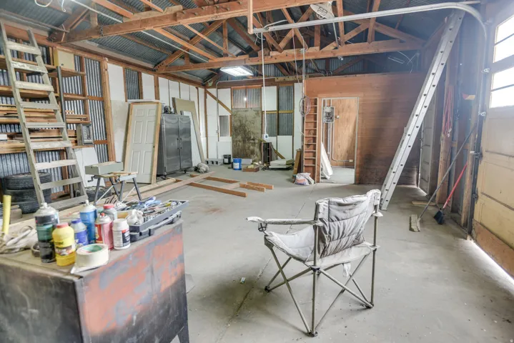 Miscellaneous room featuring vaulted ceiling and unfinished concrete floors