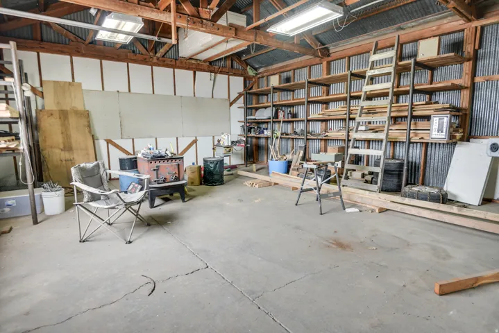 Garage with metal wall and white fridge
