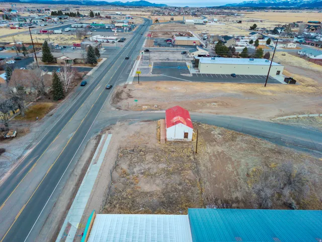Bird's eye view of industrial structures and a mountain backdrop