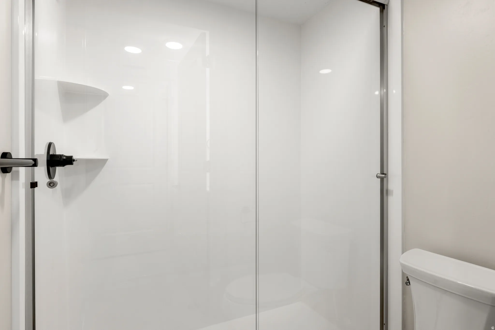 Full bathroom with a stall shower and recessed lighting