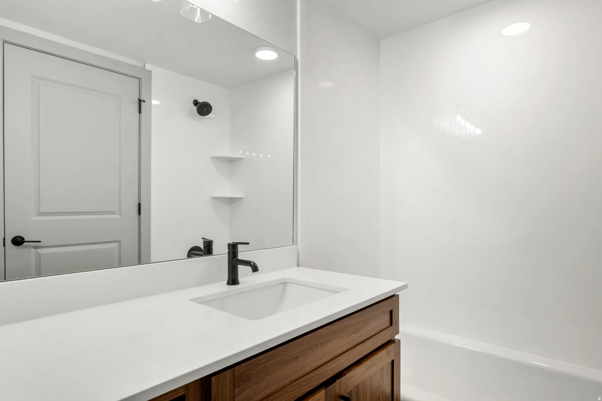 Bathroom featuring vanity, recessed lighting, and shower / tub combination