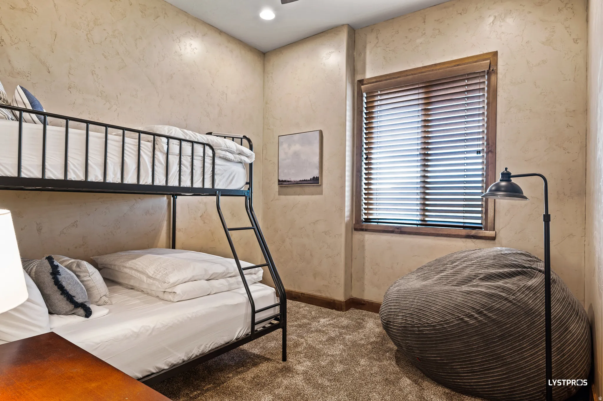 Bedroom featuring carpet, a textured wall, and recessed lighting
