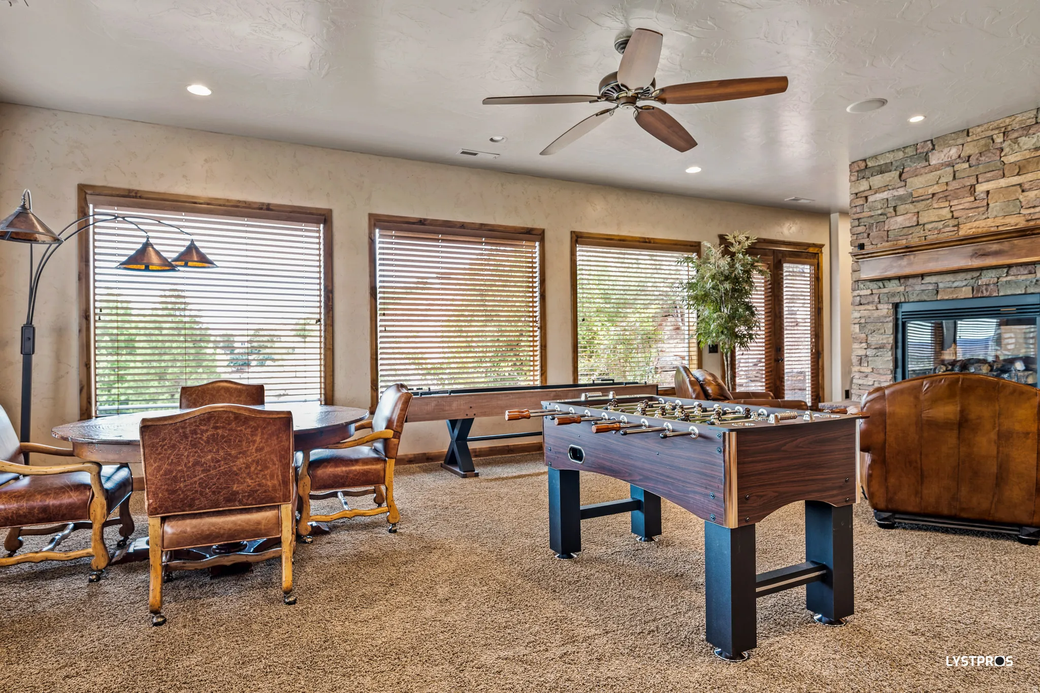 Playroom featuring a fireplace, recessed lighting, and ceiling fan
