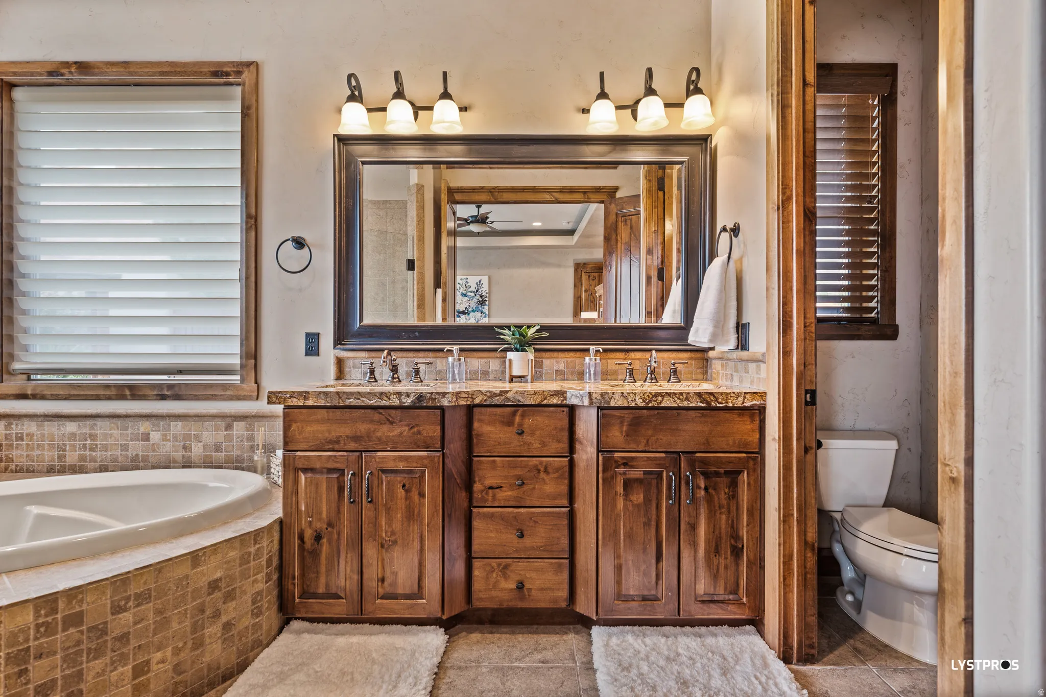 Bathroom featuring double vanity and a bath