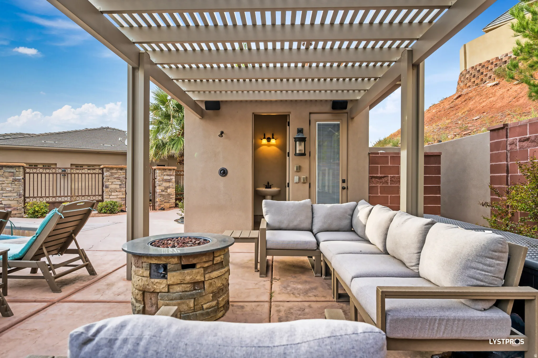 Fenced backyard featuring a patio, a pergola, and an outdoor fire pit