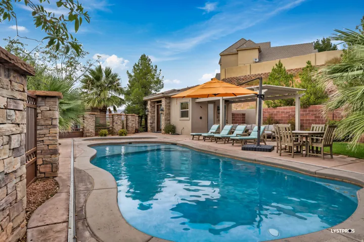 View of swimming pool featuring a fenced backyard, a patio area, and an outbuilding