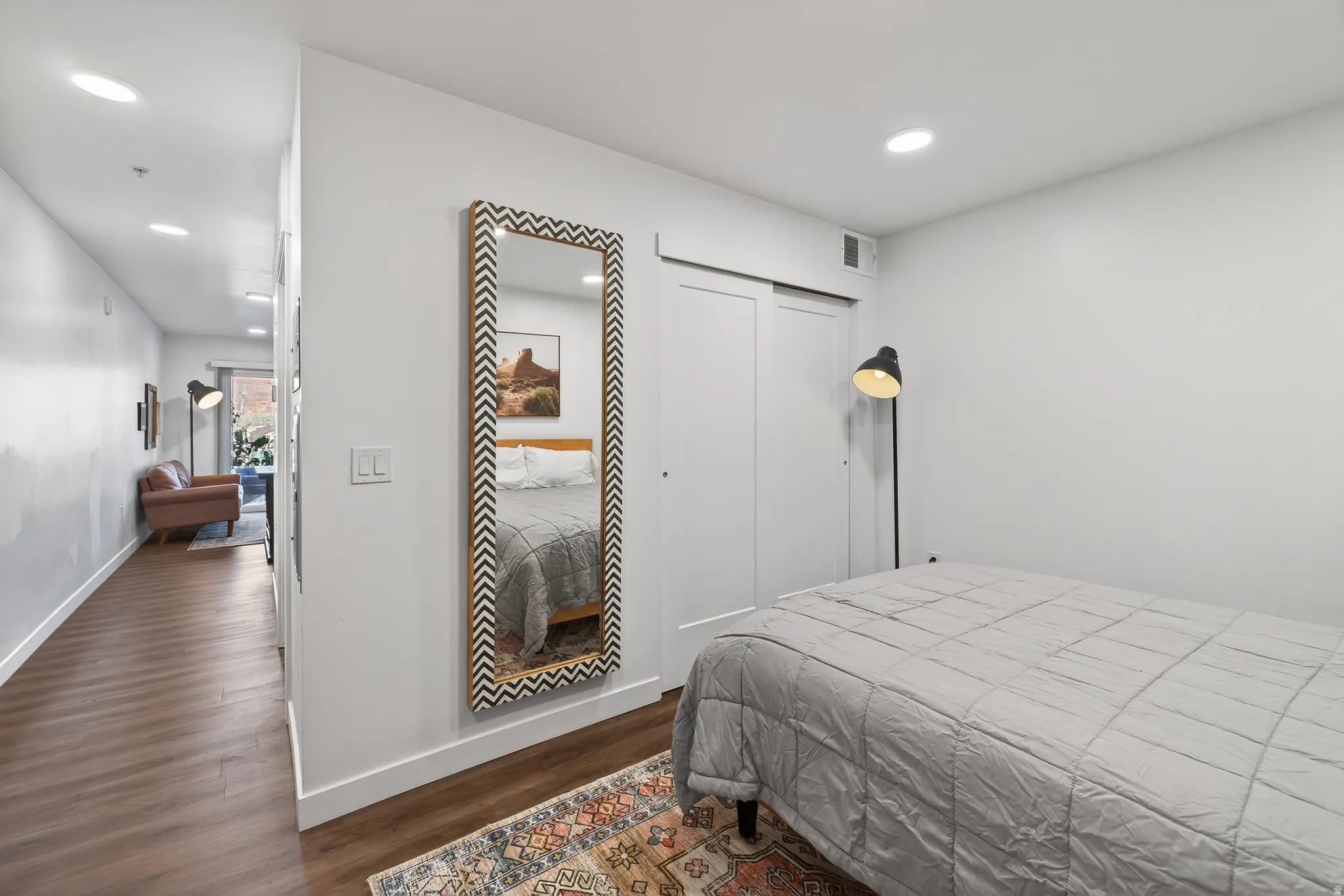 Bedroom featuring dark wood-style flooring, recessed lighting, and a closet
