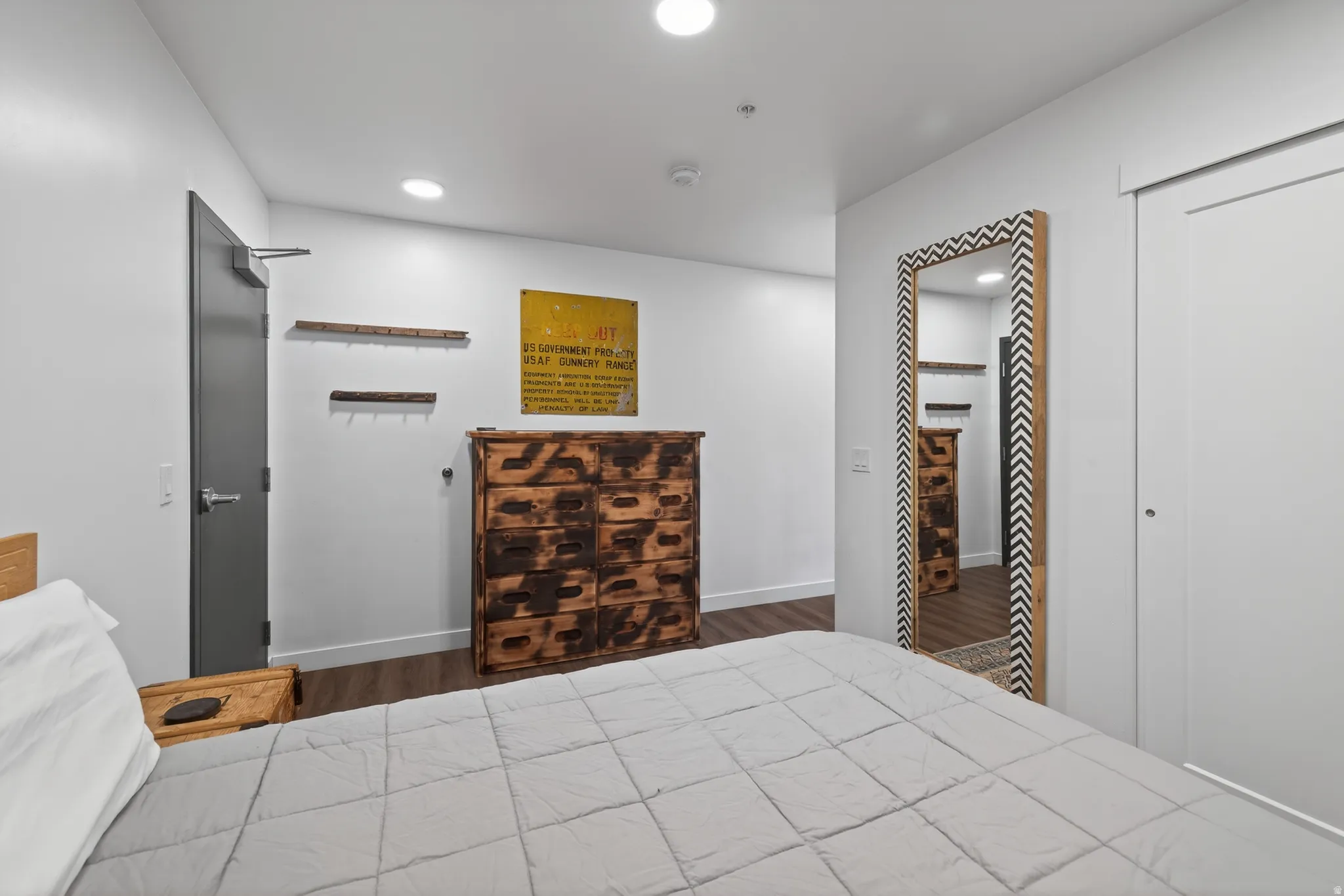 Bedroom with dark wood-style flooring and recessed lighting