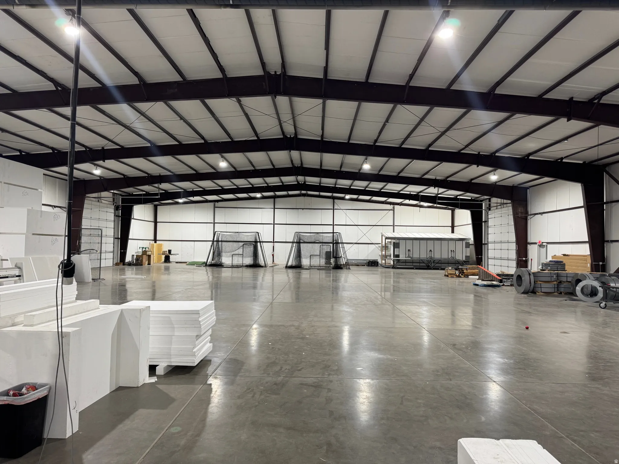 Misc room featuring vaulted ceiling and metal wall