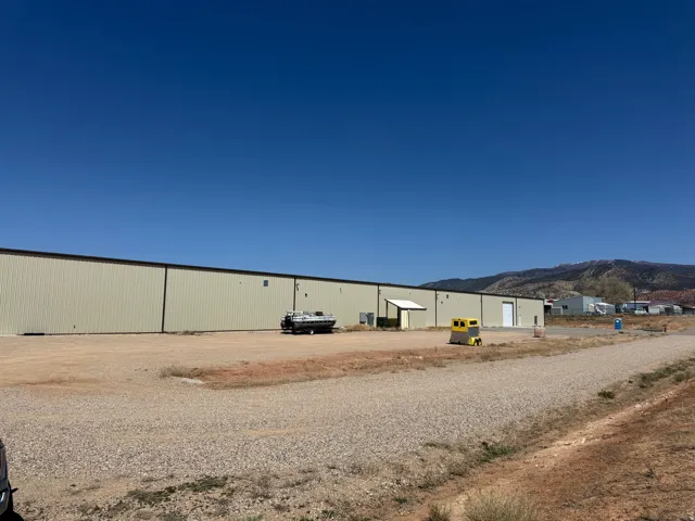 View of yard with an outdoor structure and a pole building