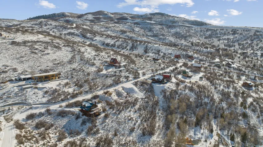 Snowy aerial view featuring a mountain view