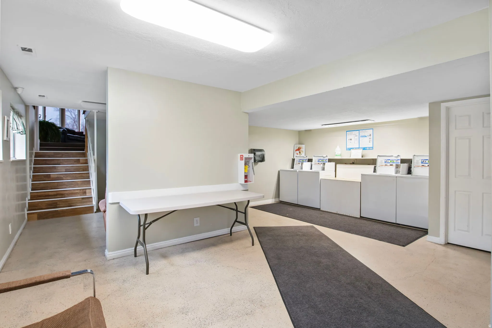 Below grade area with stairs, washer and clothes dryer, and healthy amount of natural light