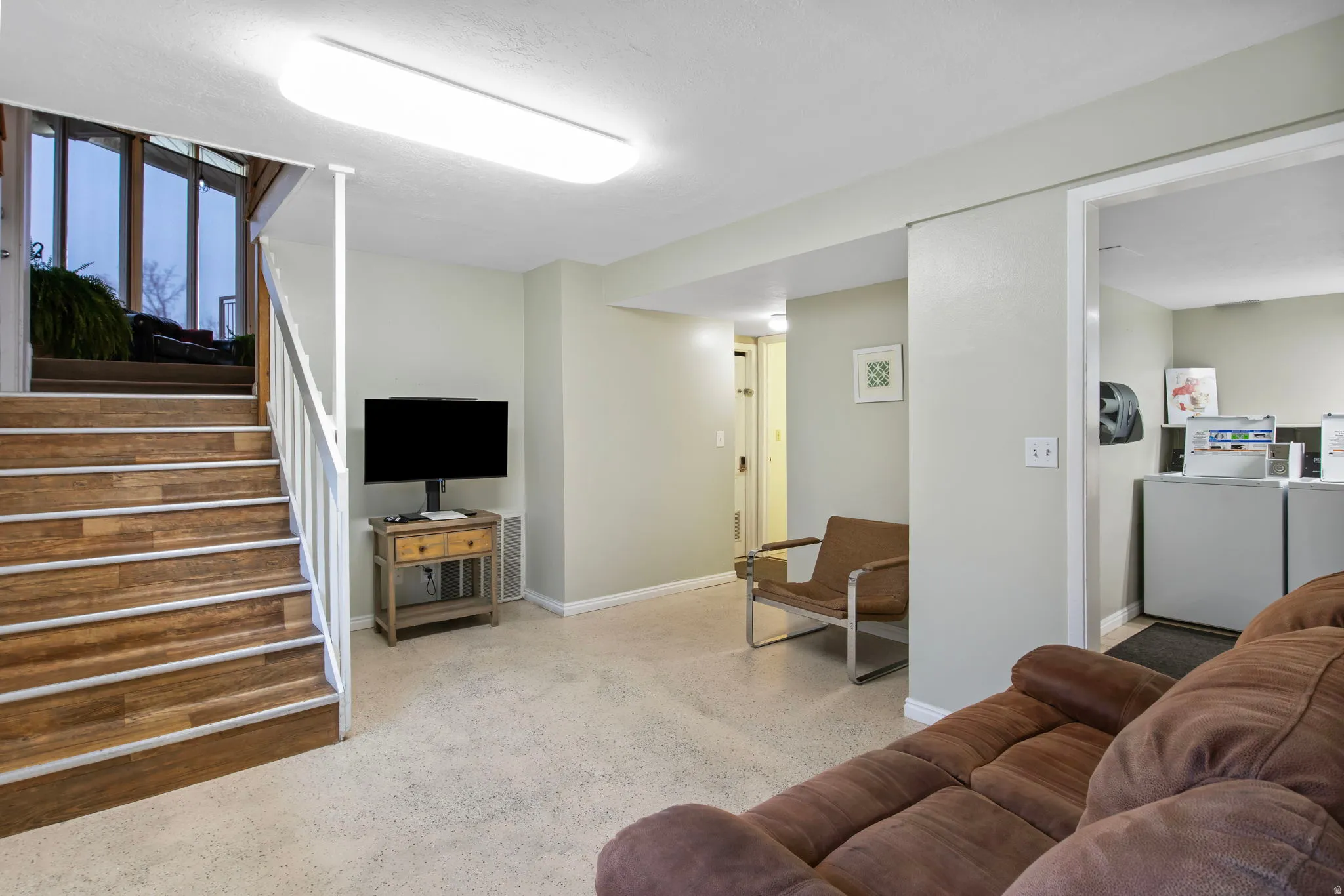 Living room featuring baseboards and stairs