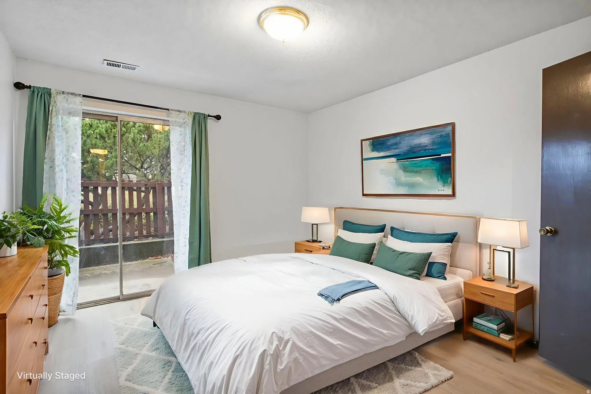 Bedroom featuring access to exterior and wood finished floors