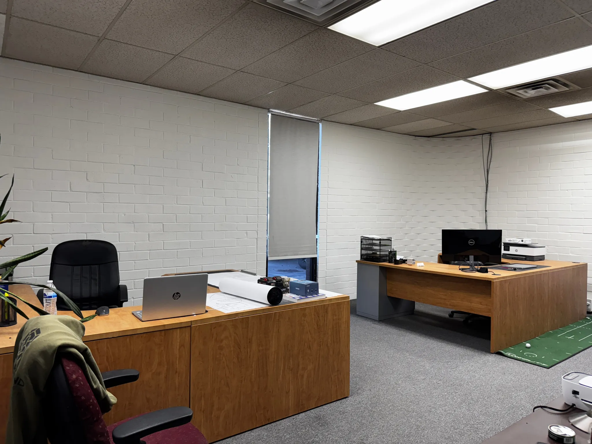 Office with a paneled ceiling