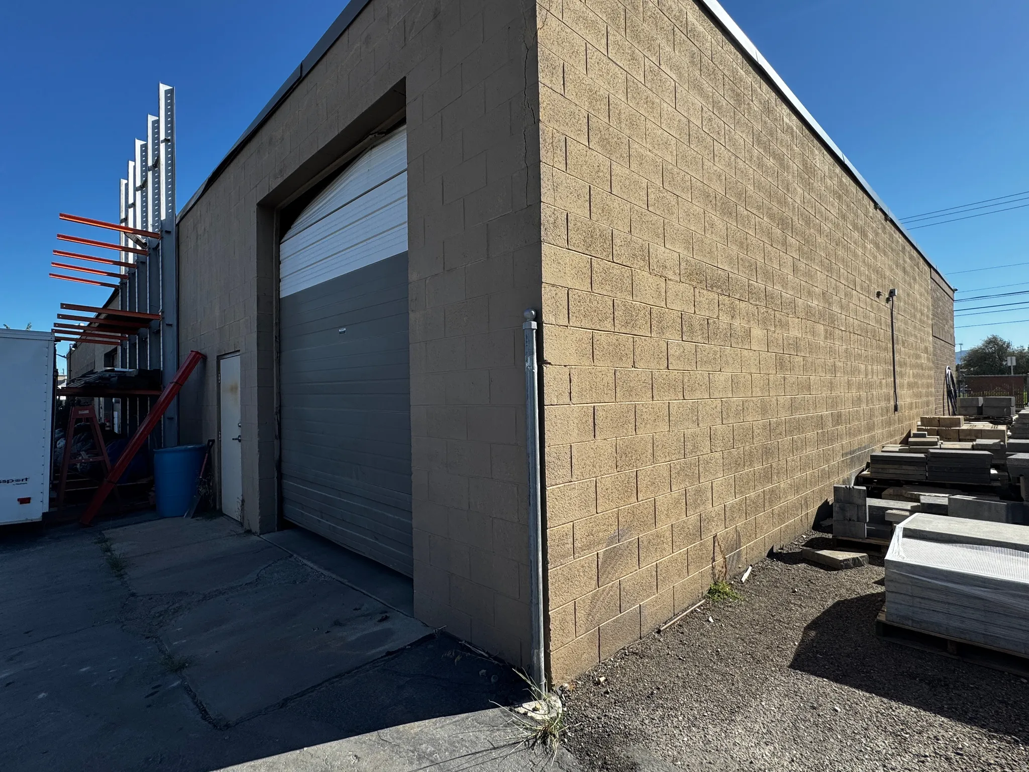 View of side of property featuring concrete block siding and a garage
