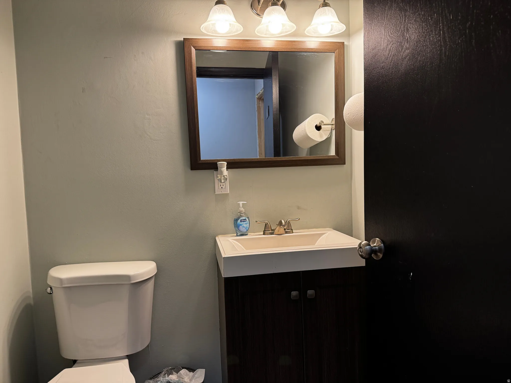 Half bathroom featuring vanity and toilet