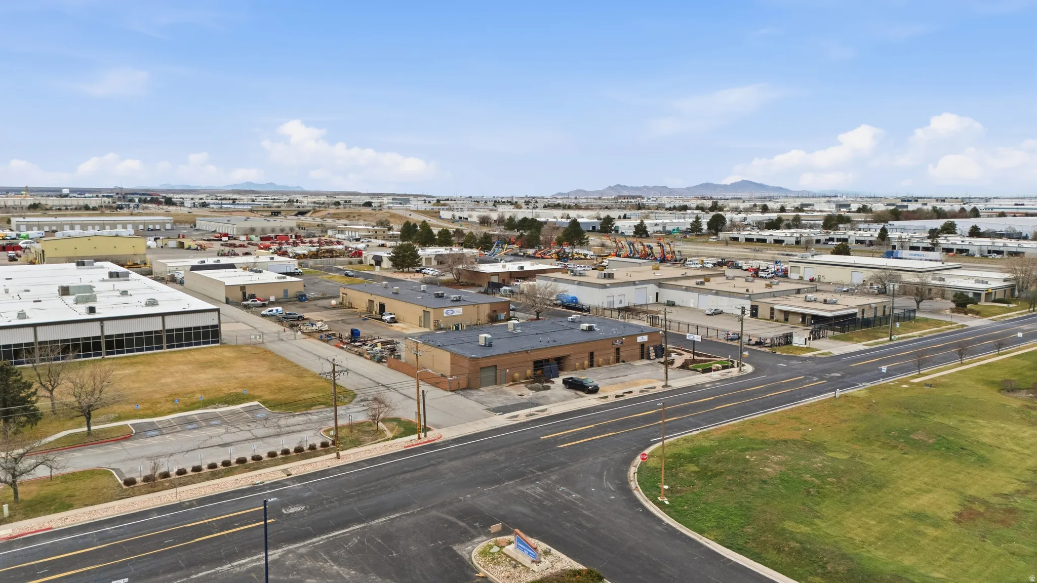 Drone / aerial view of industrial structures and a mountain backdrop