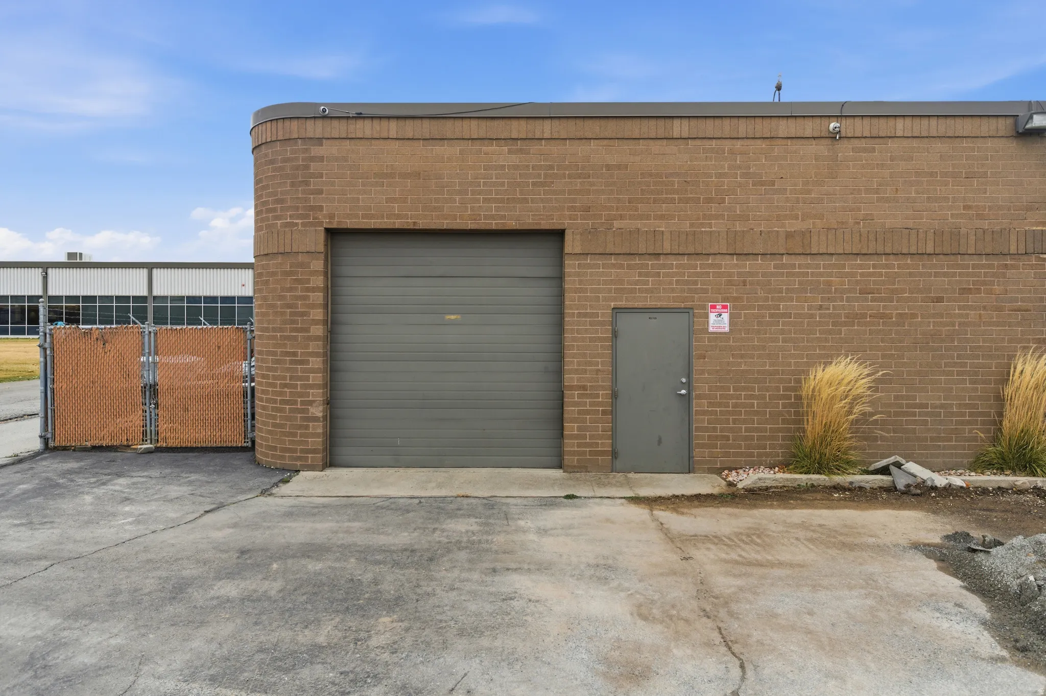 Garage featuring concrete driveway and a gate