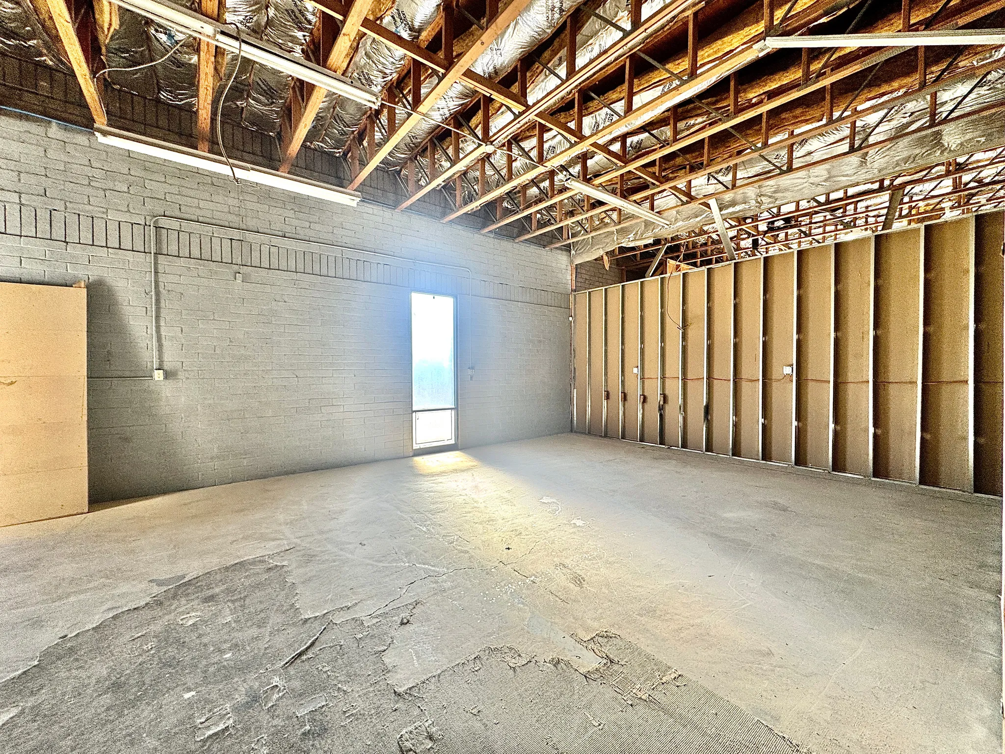 Misc room with unfinished concrete flooring and a garage