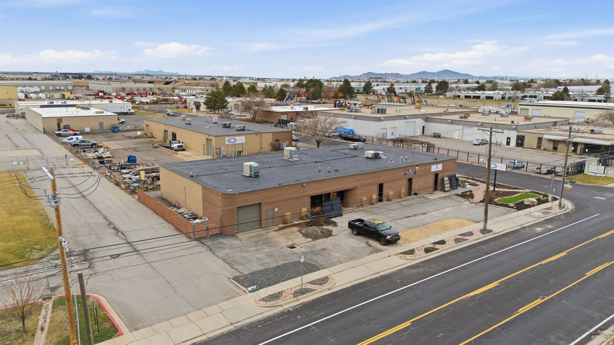 Bird's eye view of industrial structures and a mountain backdrop