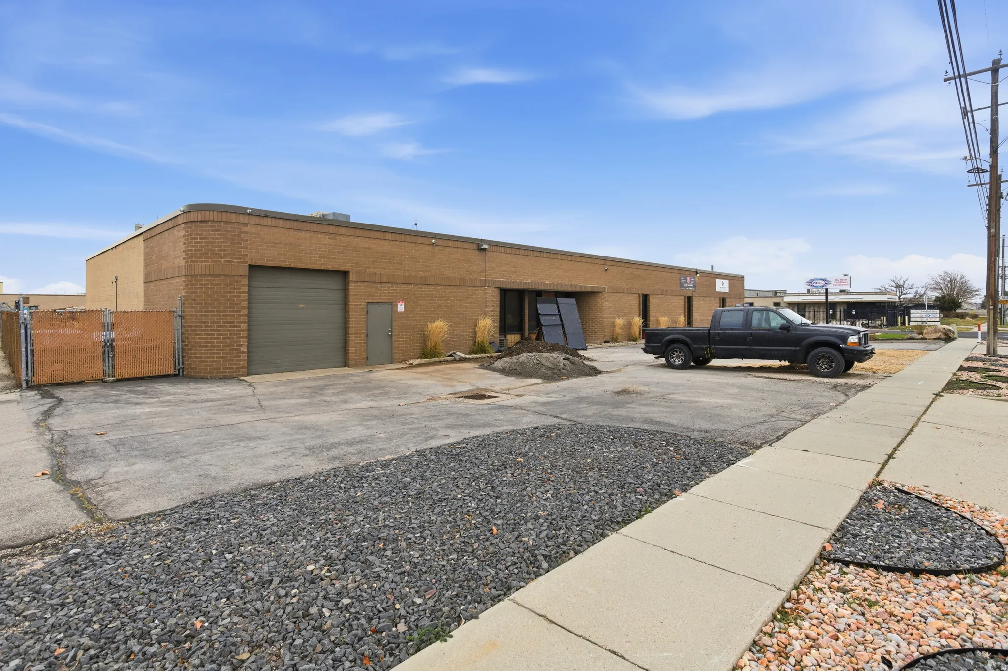 View of property featuring driveway and a garage
