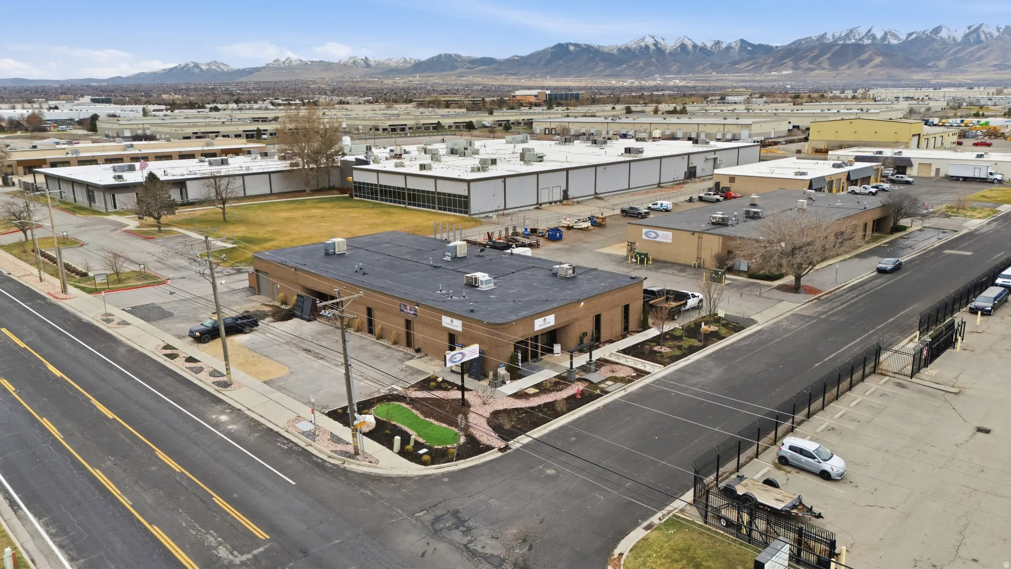 Drone / aerial view of industrial structures and a mountainous background