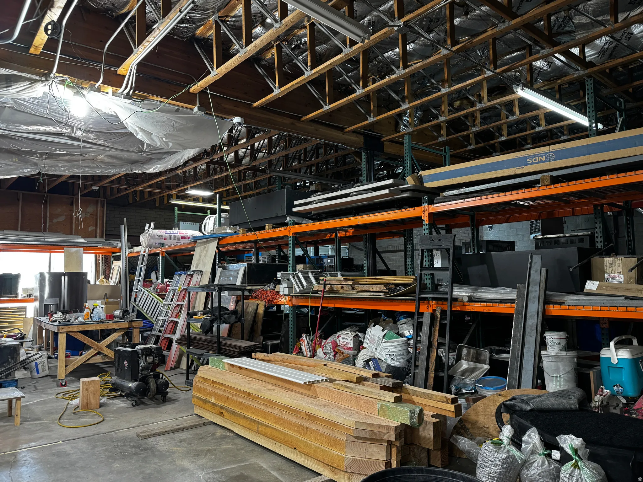 Miscellaneous room with unfinished concrete floors and a workshop area