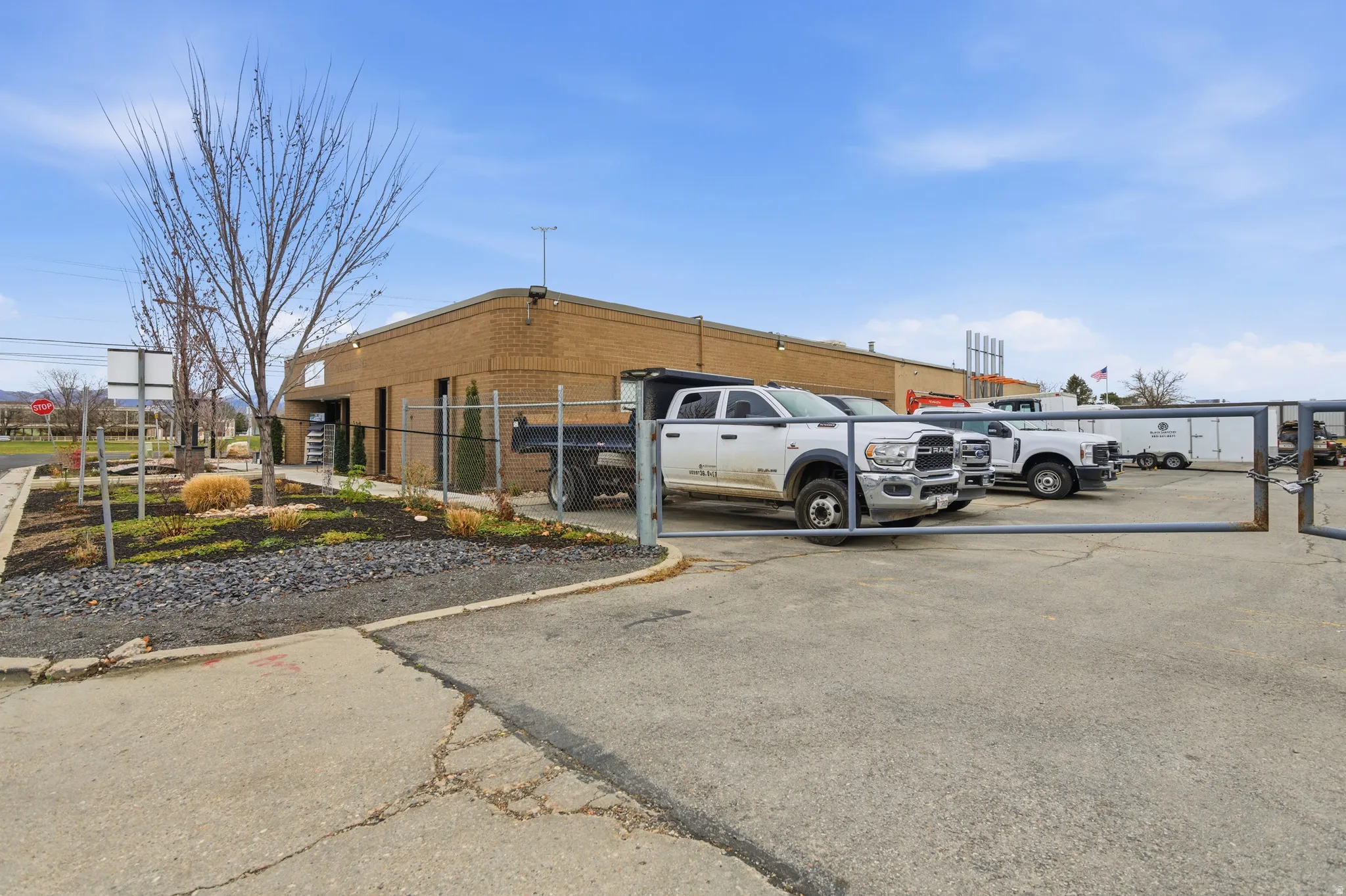 Uncovered parking lot with a fenced front yard and a gate