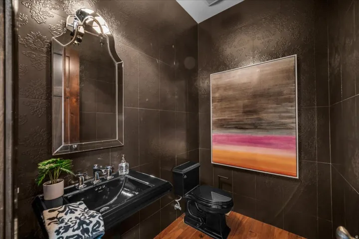 Half bathroom featuring toilet and a sink