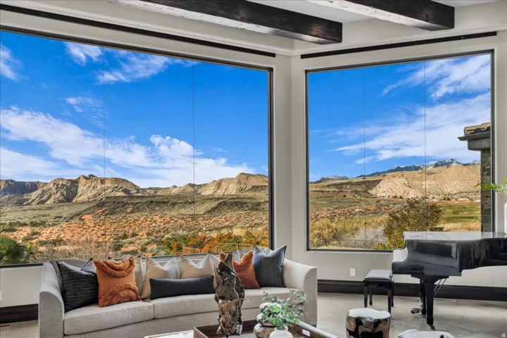 Living area featuring beamed ceiling and a mountain view