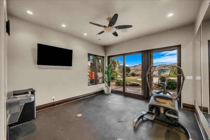 Workout room featuring a ceiling fan and recessed lighting