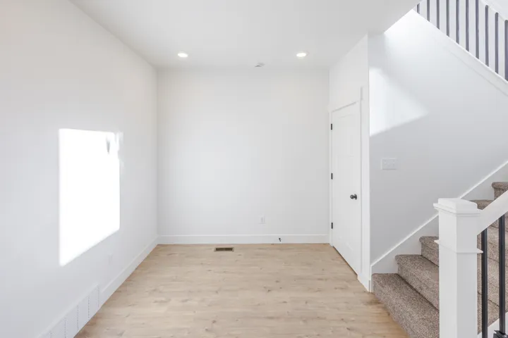 Bright interior space featuring light wood-finish flooring, recessed lighting, and white baseboards