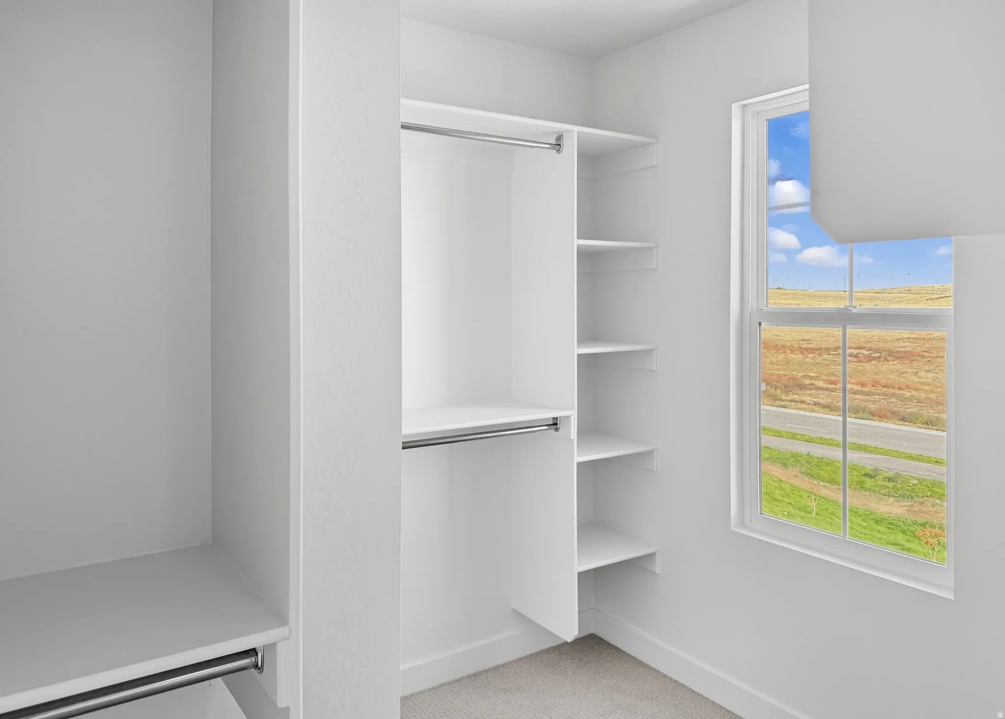 Spacious closet with light colored carpet
