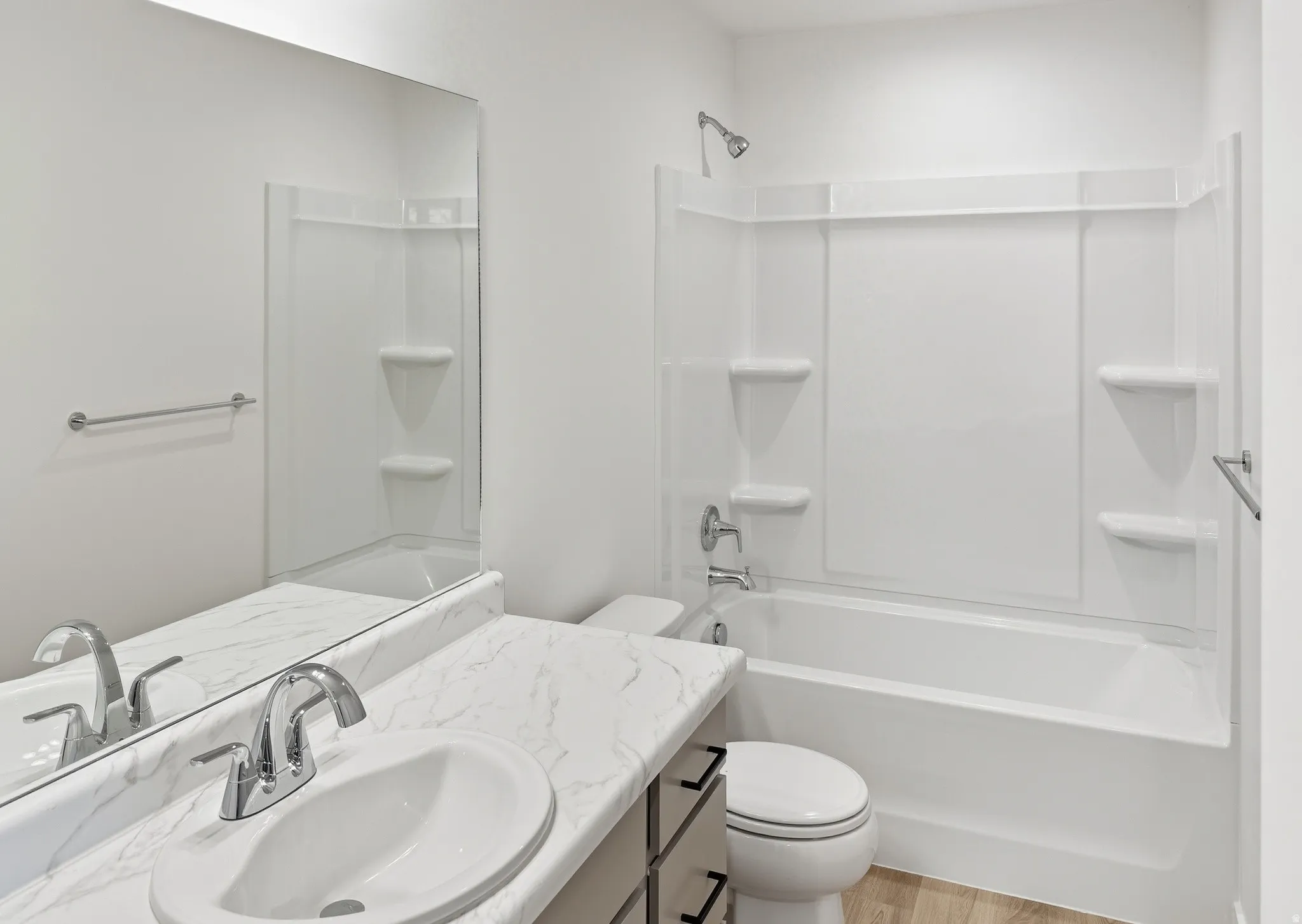 Full bath featuring vanity, shower / washtub combination, and light wood finished floors