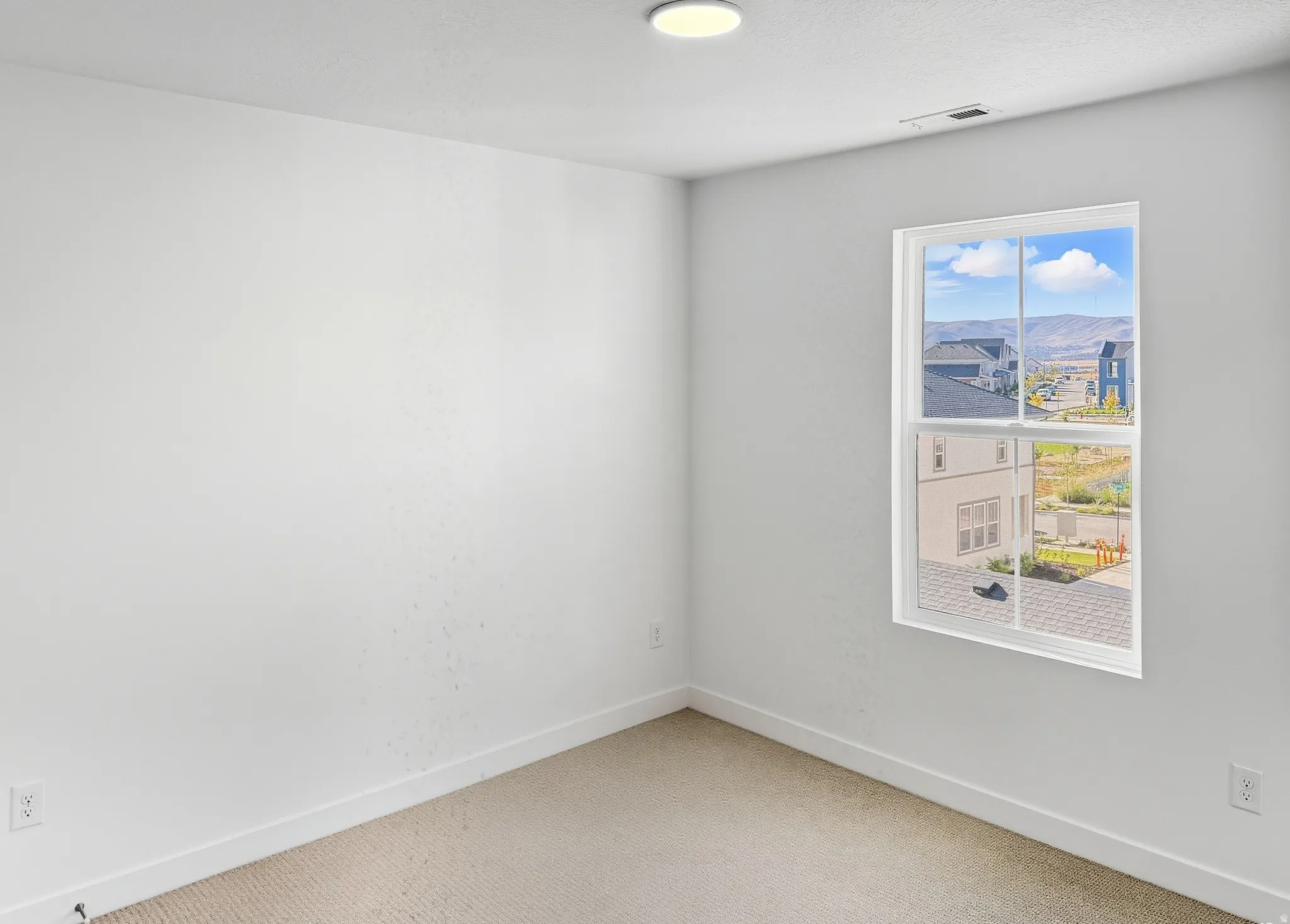 Carpeted empty room featuring baseboards