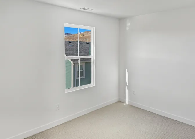 Carpeted spare room with baseboards