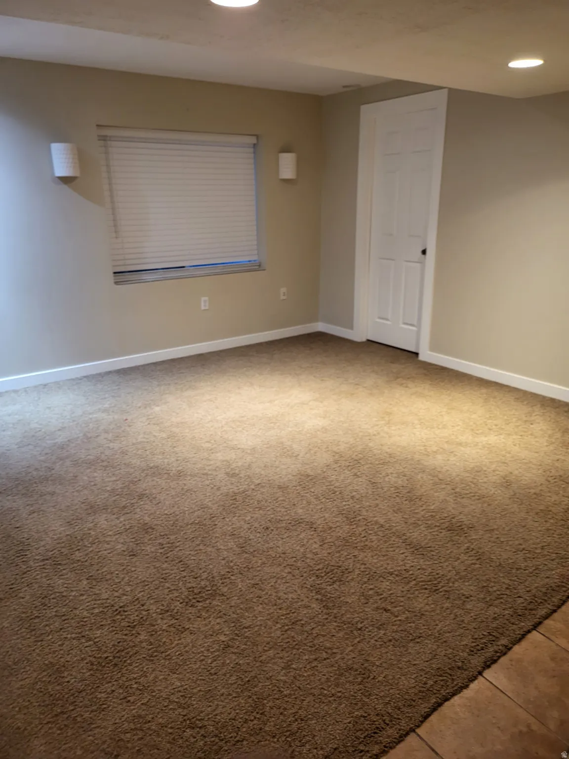 Spare room featuring light colored carpet and recessed lighting