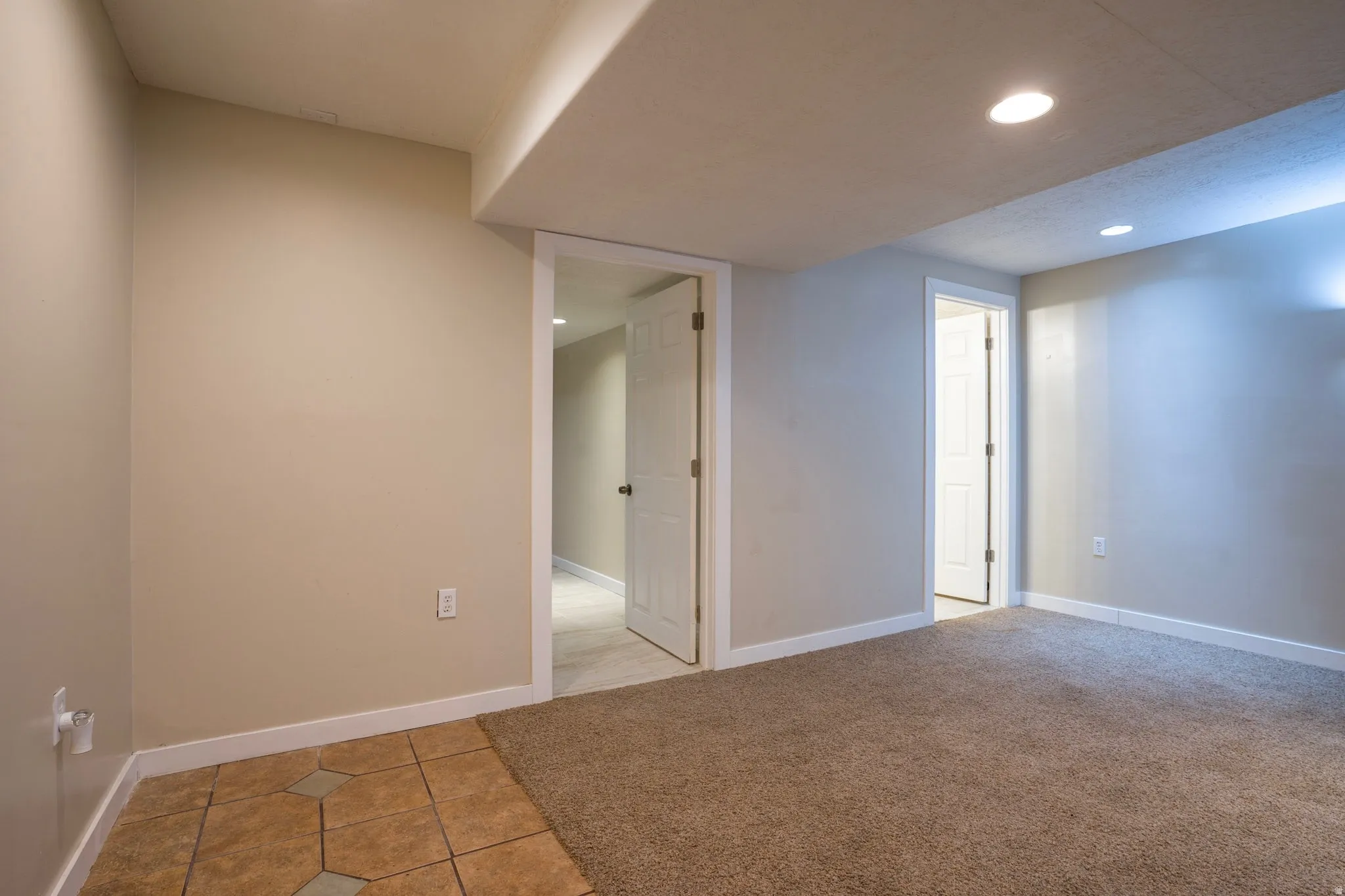 Empty room with recessed lighting and light tile patterned flooring