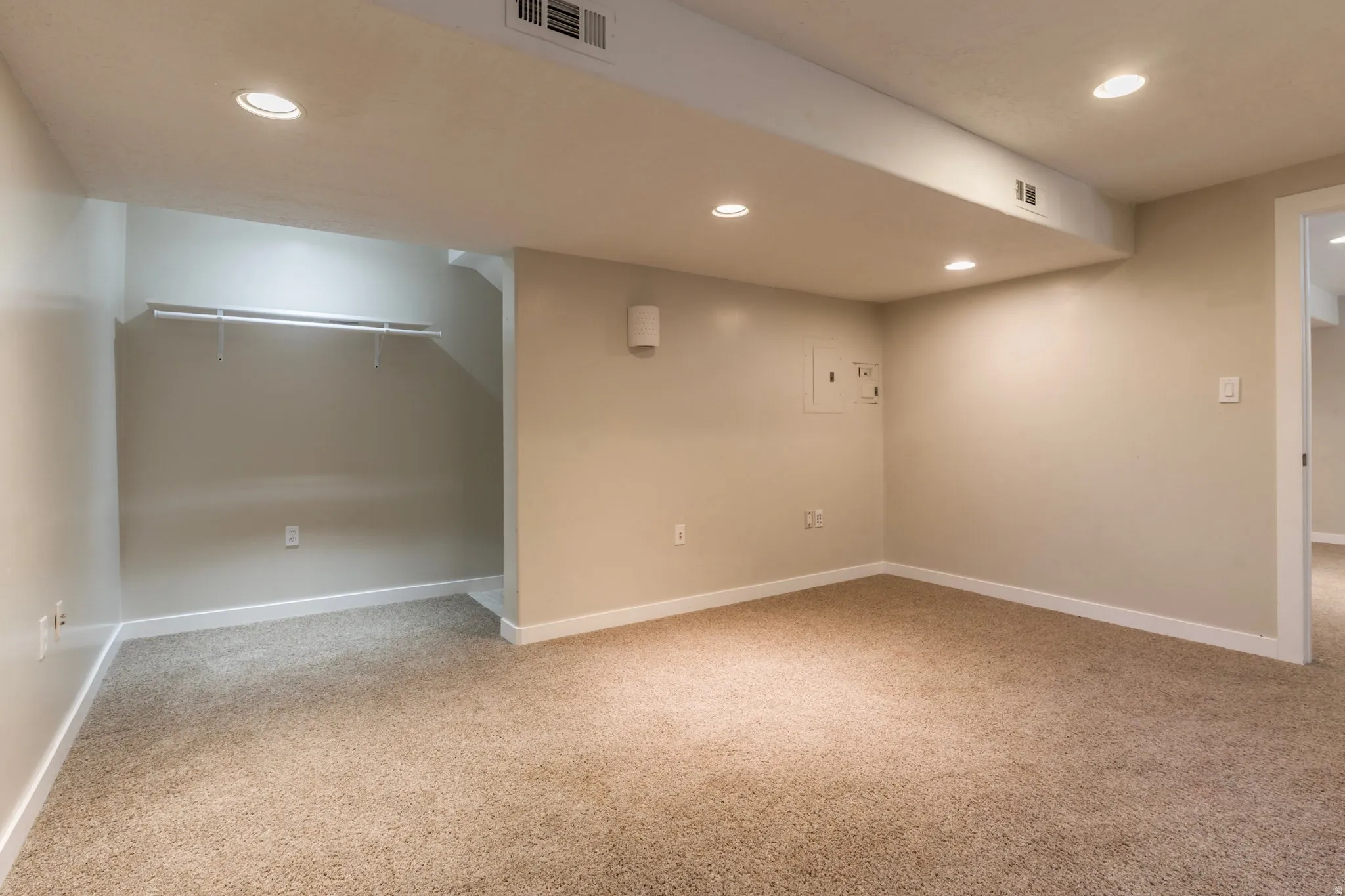 Finished basement featuring light carpet and recessed lighting