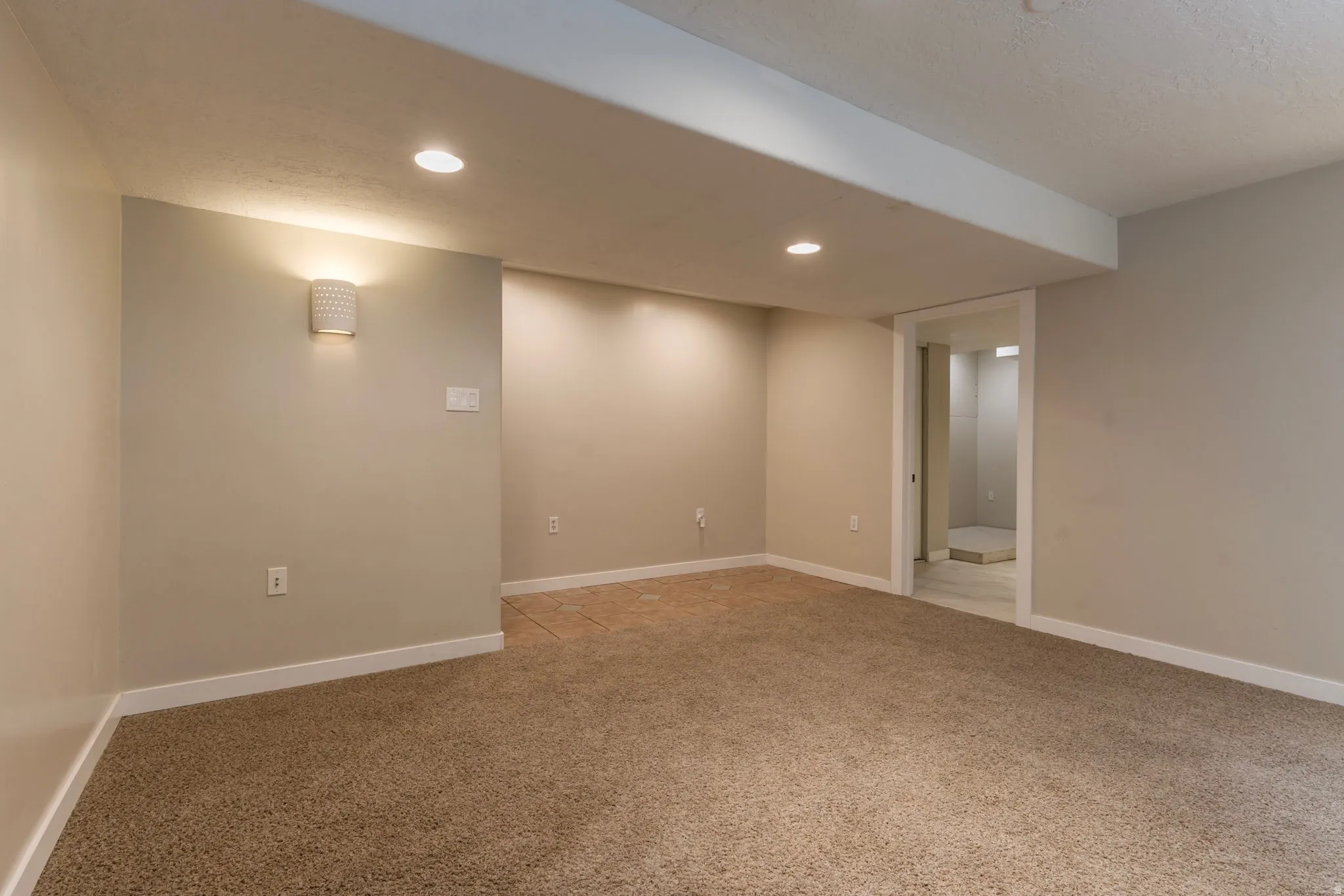 Empty room featuring light colored carpet and recessed lighting