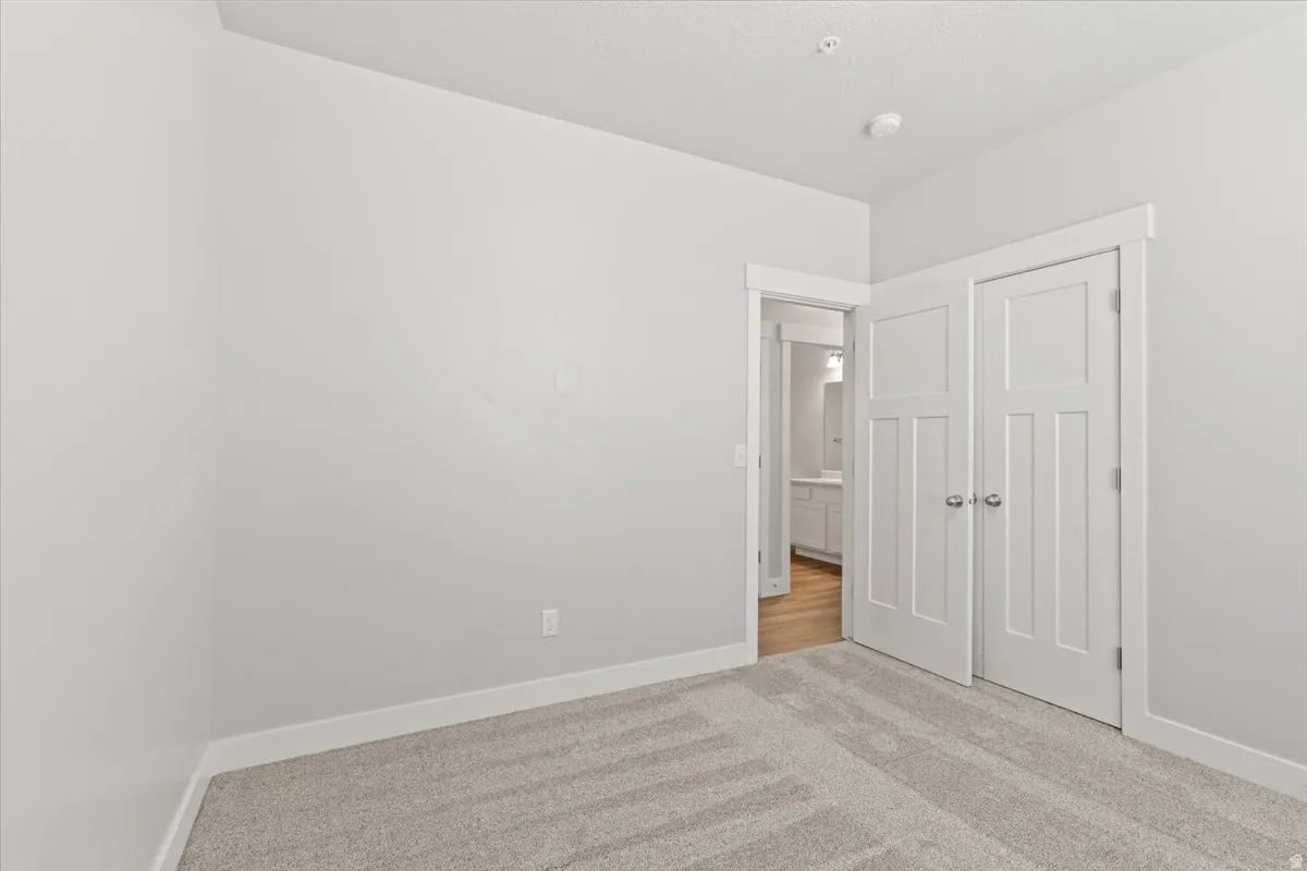 Unfurnished bedroom featuring carpet and a closet