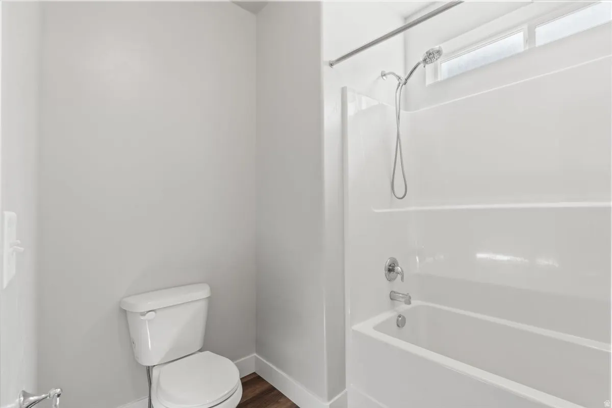 Full bathroom featuring bathing tub / shower combination and toilet