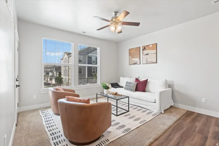 Living room with baseboards and ceiling fan
