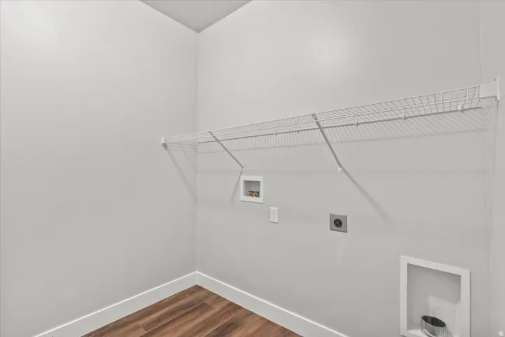 Laundry area featuring hookup for a washing machine, dark wood-style floors, and electric dryer hookup