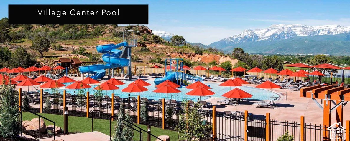 Expansive pool area featuring multiple water slides and a large, irregularly shaped swimming pool