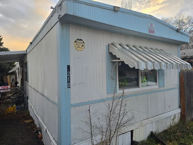View of property exterior at dusk