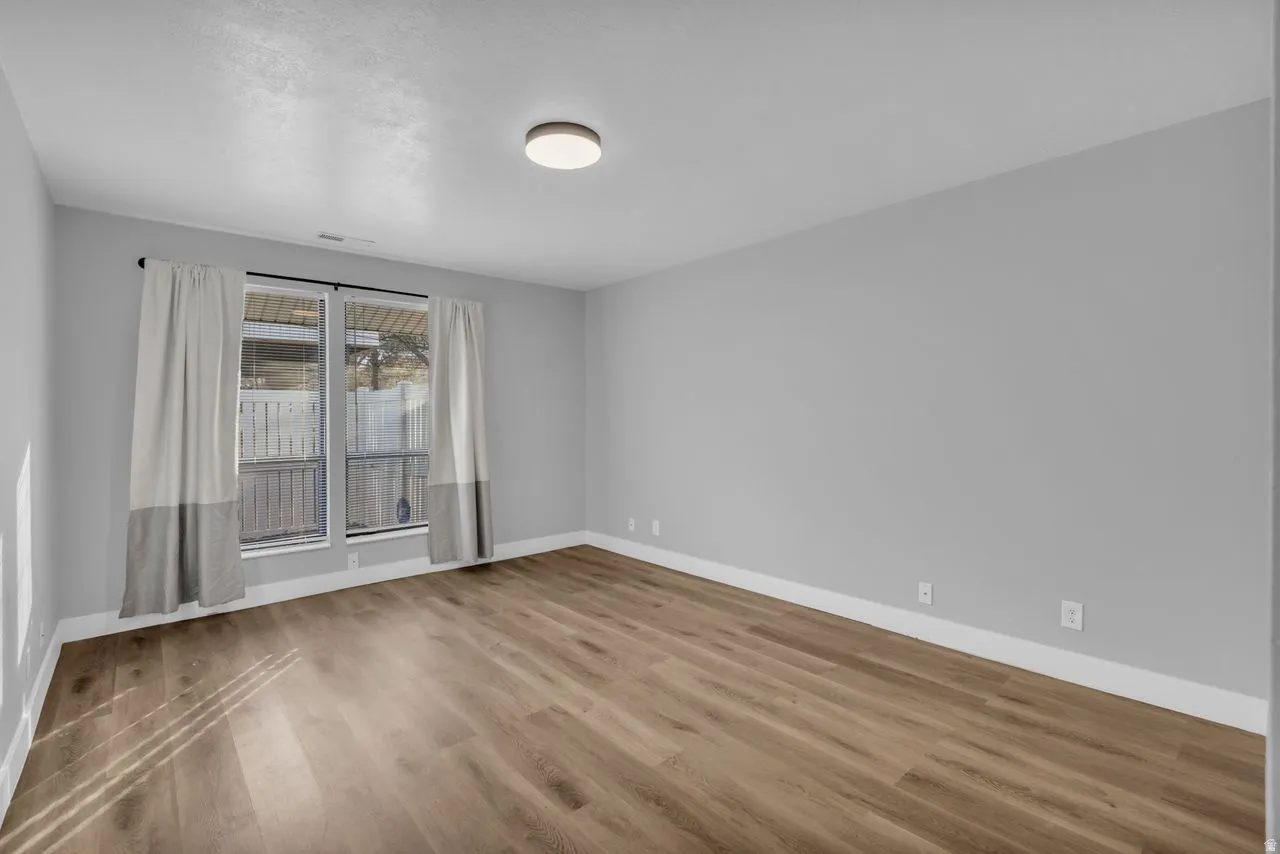 Spare room featuring baseboards and light wood-style flooring