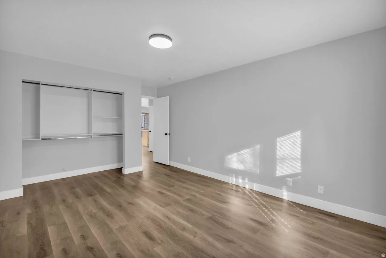 Unfurnished bedroom featuring a closet and wood finished floors