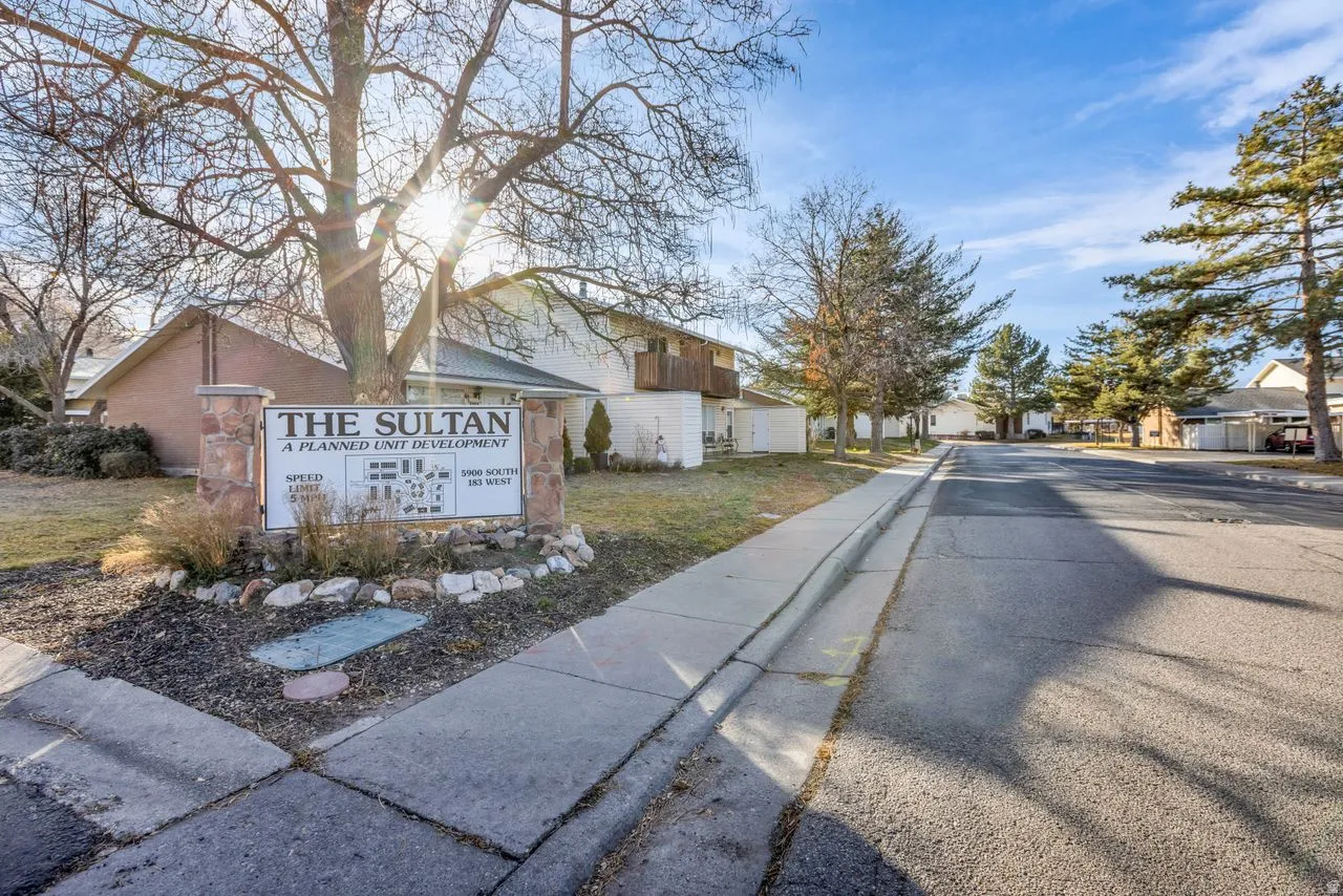View of asphalt road with sidewalks, curbs, and a residential view